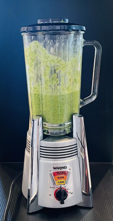 In this photograph by Elizabeth Karmel, the Chimichurri sauce ingredients are pureed in a blender until they become a silky green sauce. 