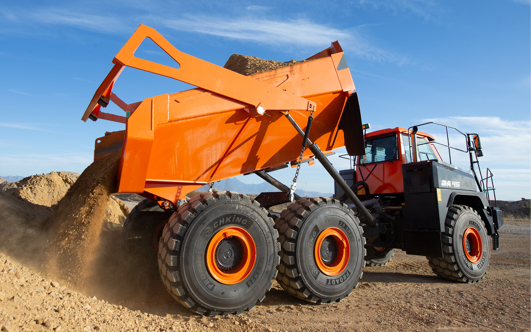 The DEVELON DA30-5 and DA45-5 articulated dump trucks and their features are shown in suburban, desert and studio environments.