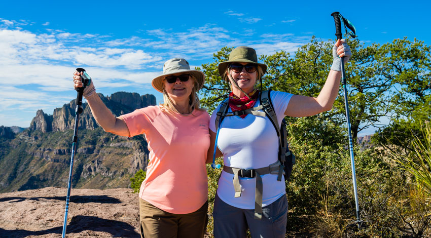 Two female hikers smile at the camera