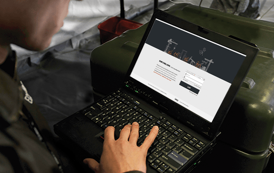 Photo of an equipment owner monitoring telematics from a laptop.