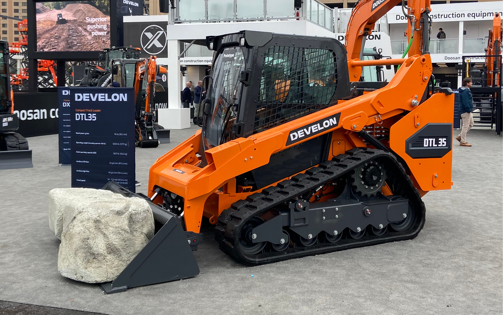 A DEVELON compact track loader and bucket attachment on display at CONEXPO-CON/AGG.