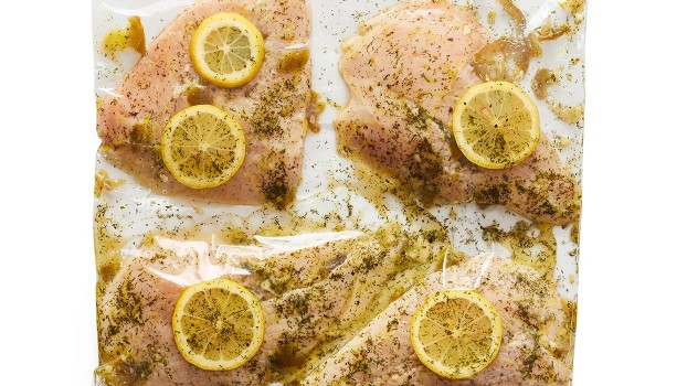 plastic bag of marinated chicken with lemon