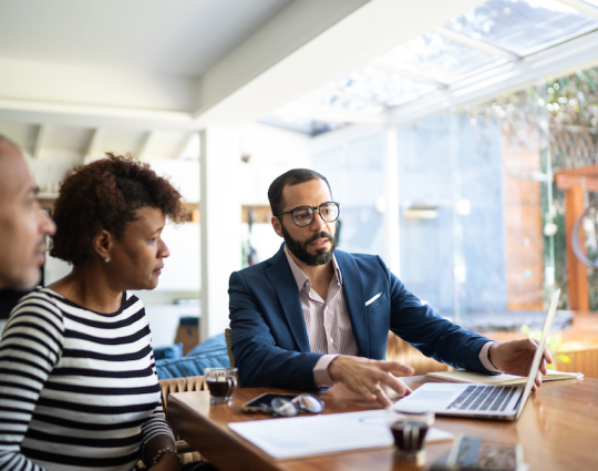 three coworkers reviewing computer