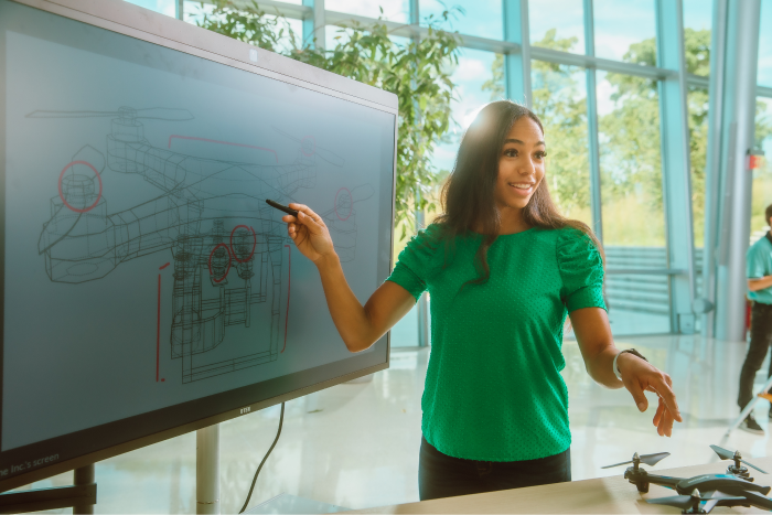 woman standing at whiteboard