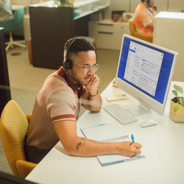 Man at office desk on phone