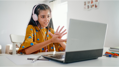 Student clapping in front of laptop